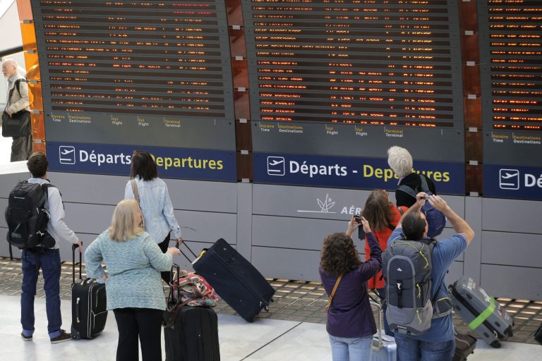Travelers look at departure boards at Paris Charles de Gaulle Airport in Roissy, near Paris, Monday, Sept. 15, 2014. At least half of Air France flights around the world were canceled Monday as pilots kicked off a weeklong strike, angry that the airline is shifting jobs and operations to a low-cost carrier to better keep up with competition. (AP Photo/Christophe Ena)