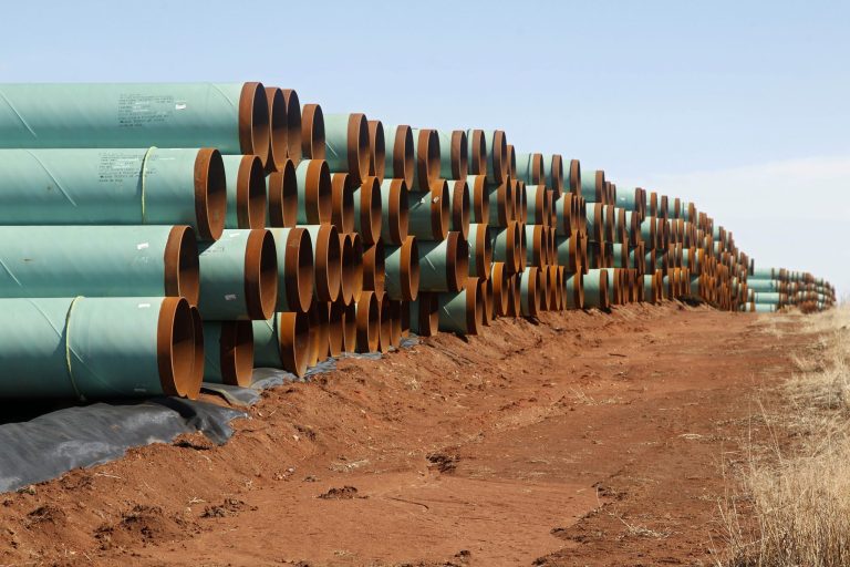 Miles of pipe ready to become part of the Keystone Pipeline are stacked in a field near Ripley, Okla. (AP/Sue Ogrocki)