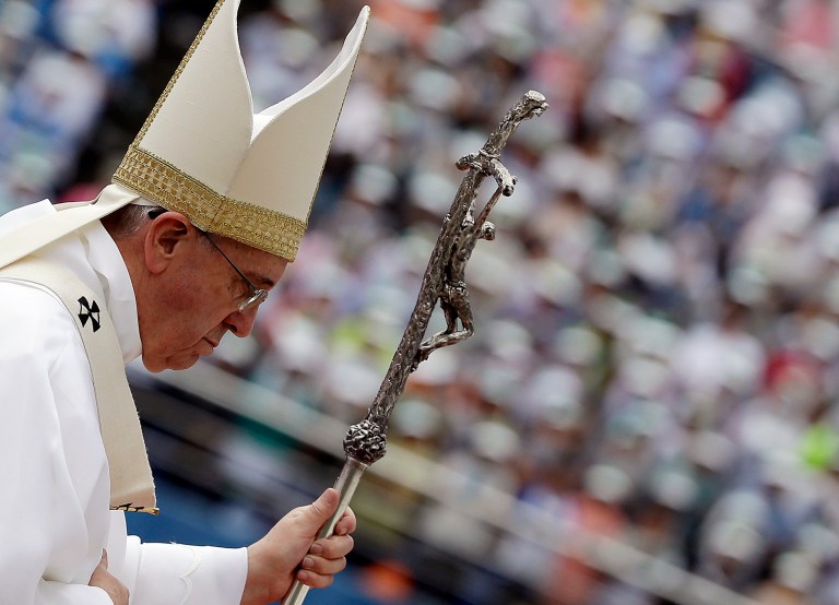 Pope Francis walks with his pastoral staff as he arrives to celebrate a mass at a soccer stadium in Daejeon, South Korea, Friday, Aug. 15, 2014. Tens of thousands of Asian Catholics gave a boisterous welcome to Pope Francis on Friday as he celebrated his first public Mass in South Korea, a country with a small but growing church that is seen by the Vatican as a model for the rest of the world.(AP Photo/Gregorio Borgia)