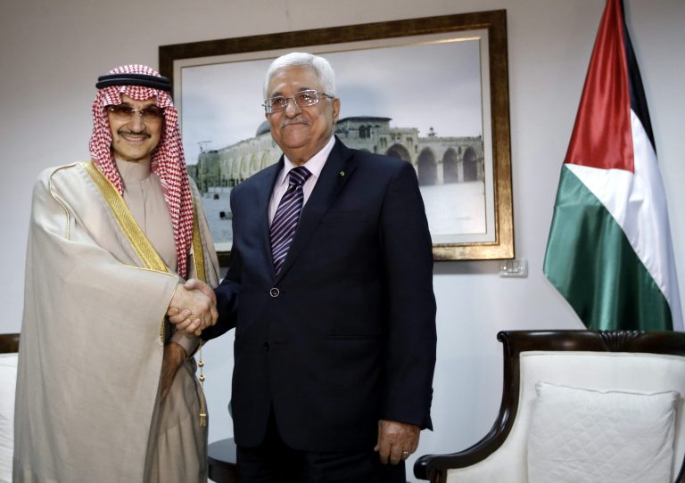 Palestinian President Mahmoud Abbas, right, shakes hands with Saudi Prince Alwaleed bin Talal, during their meeting in the West Bank city of Ramallah, Tuesday, March 4, 2014. (AP Photo/Mohamad Torokman, Pool)