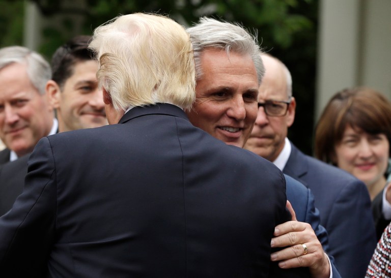 President Donald Trump hugs House Majority Leader Kevin McCarthy.