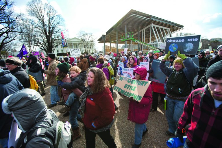 Protestors march in front of the White House in Washington during a rally calling on President Barack Obama to reject the Keystone XL oil pipeline from Canada, as well as act to limit carbon pollution from power plants and 