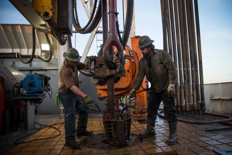 Workers with Raven Drilling line up pipe while drilling for oil in the Bakken shale formation on July 23, 2013 outside Watford City, North Dakota. (Photo by Andrew Burton/Getty images)