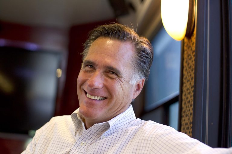 In this June 8, 2012, photo, Republican presidential candidate, former Massachusetts Gov. Mitt Romney smiles has he talks with his staff.