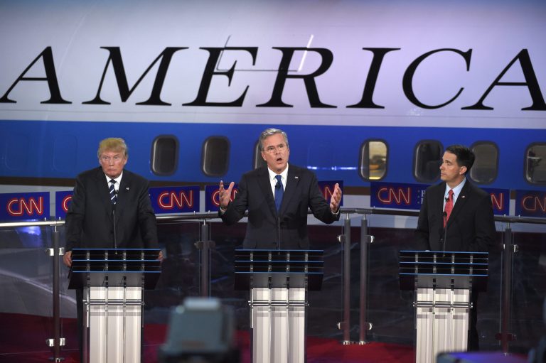 Republican presidential candidate, former Florida Gov. Jeb Bush, center, speaks as Donald Trump, left, and Scott Walker look on. (AP Photo/Mark J. Terrill)