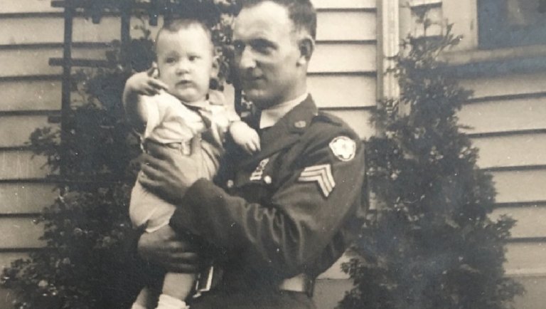 Pvt. Langille holding his son Steven outside his Medford, Mass. home. (Langille family photo)
