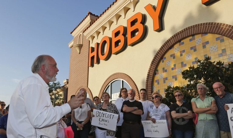 Rev. Bruce Prescott, left, speaks during a vigil outside a Hobby Lobby store in Edmond, Okla., Monday. (AP/Sue Ogrocki)