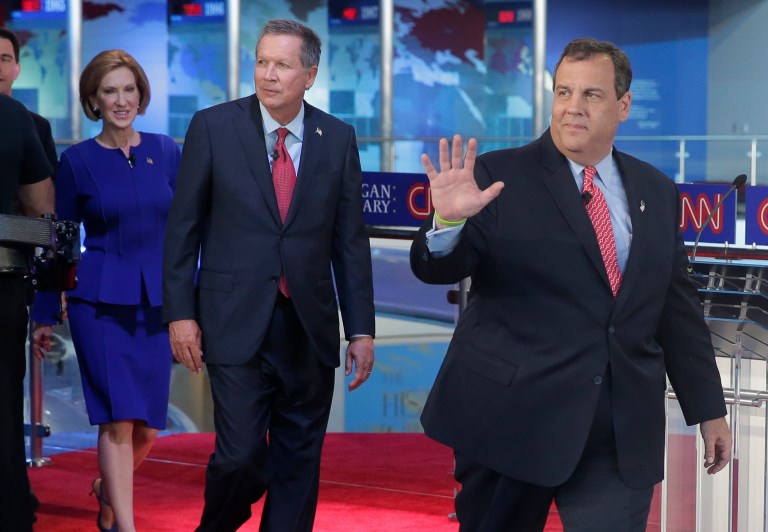 Republican presidential candidates Chris Christie, right, John Kasich, center, and Carly Fiorina enter the debate stage. (AP Photo/Chris Carlson)