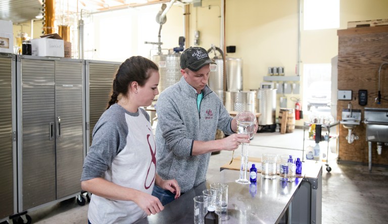 Caitlin Bagenstose and Logan Snyder make hand sanitizer at the Eight Oaks Farm Distillery in New Tripoli, Pa., Monday, March 16, 2020. The distillery has been temporarily converted into a production line for the alcohol-based disinfectant.