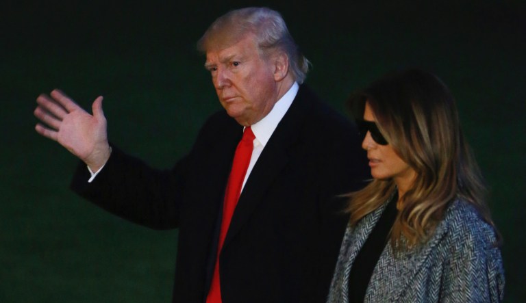 President Donald Trump and his wife Melania walk on the south lawn as the arrive at the White House, Thursday, Nov. 21, 2019, in Washington. (AP Photo/Steve Helber)