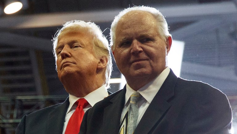 President Donald Trump and Rush Limbaugh, stand with Lee Greenwood as he sings "I'm Proud To Be An American" during a rally at Show Me Center, Monday, Nov. 5, 2018, in Cape Girardeau, Mo.