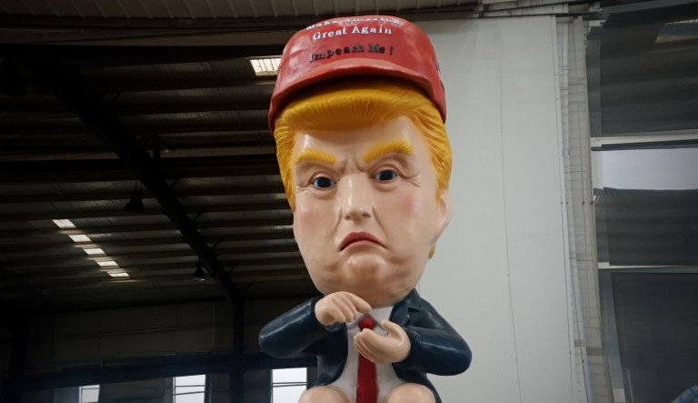 A robot shaped like President Trump sitting on a toilet is shown.