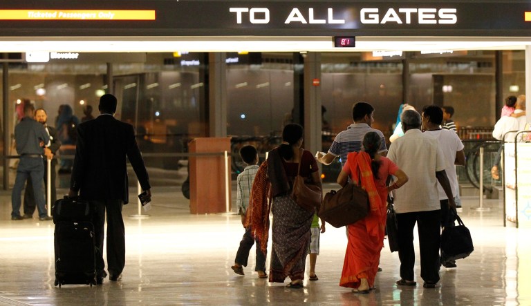 Passengers enter a gate at Washington Dulles International Airport in Chantilly, Va., Saturday, Sept. 10, 2011.