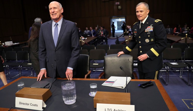 Director of National Intelligence Dan Coats, left, and Defense Intelligence Agency Dir. Lt. Gen. Robert Ashley Jr., right, take their seats to testify before the Senate Armed Services Committee on Capitol Hill in Washington, Tuesday, March 6, 2018. (AP Photo/Pablo Martinez Monsivais)