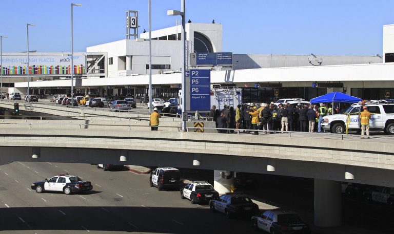Police, emergency response vehicles and officials are positioned outside Terminal 3 at Los Angeles International Airport on Nov. 1. (AP/Ringo H.W. Chiu)