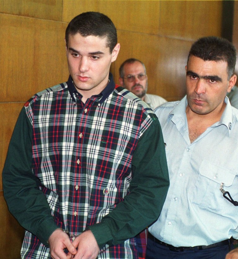 File - In this July 5, 1999 file photo, Samuel Sheinbein, accused of the 1997 murder of Alfredo Tello Jr., in Maryland, is brought in handcuffs to a Tel Aviv court.  Israeli special forces raided a prison in central Israel on Sunday, killing one of the country's most notorious inmates after he seized a guard's weapon, shot three guards and barricaded himself inside the compound. Police identified the inmate as Samuel Sheinbein, an American who fled to Israel after committing a gruesome murder in Maryland in 1997 and whose case sparked a high-profile row between the two allies.(AP Photo/Nati Harnik, File)