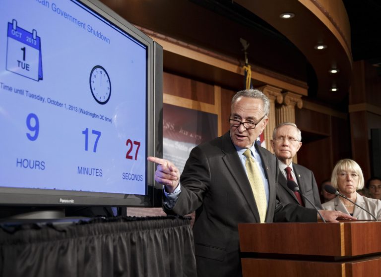 Sen. Charles Schumer, D-N.Y., points to a countdown clock during a news conference on Capitol Hill on Monday. (AP/J. Scott Applewhite)
