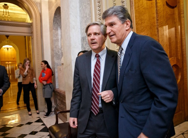 Sen. John Hoeven, R-N.D., and Sen. Joe Manchin, D-W.Va., support giving coal ash regulatory power permanently to the states. (AP Photo)