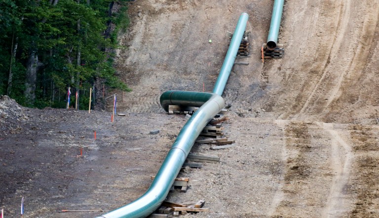 Segments of assembled pipe are lined up along a cleared section of woods where a pipeline for shale gas is under construction on Saturday, July 8, 2017 in Jackson Township, Butler County, Pa. (AP Photo/Keith Srakocic)