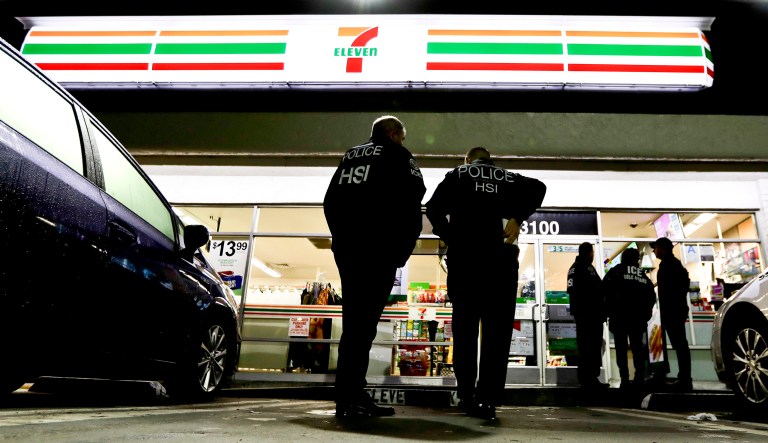 U.S. Immigration and Customs Enforcement agents serve an employment audit notice at a 7-Eleven convenience store Wednesday, Jan. 10, 2018, in Los Angeles. Agents said they targeted about 100 7-Eleven stores nationwide Wednesday to open employment audits and interview workers. (AP Photo/Chris Carlson)