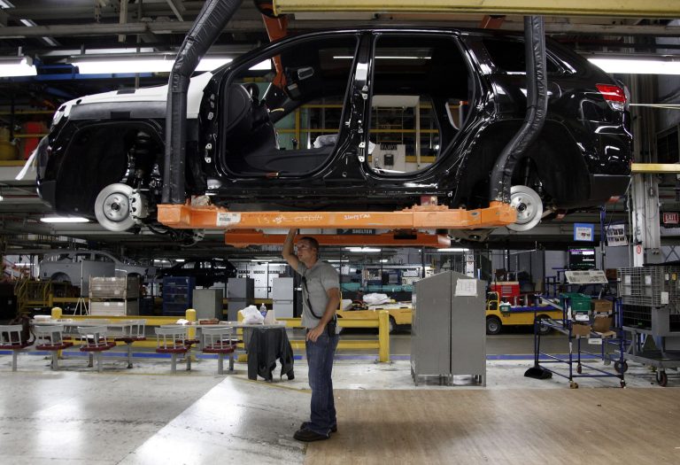   FILE - In this Wednesday, May 8, 2013 file photo, Jeff Caldwell, 29, right, a chassis assembly line supervisor, checks a vehicle on the assembly line at the Chrysler Jefferson North Assembly plant in Detroit. The U.S. economy grew at a 2.5 percent annual rate from April through June, much faster than previously estimated, according to data released Thursday, Aug. 29, 2013, by the Commerce Department. The steep revision was largely because U.S. companies exported more goods and imports declined. (AP Photo/Paul Sancya, File)  