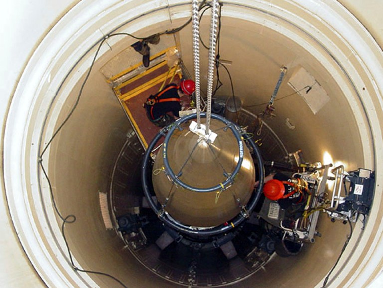 In this Image released by the U.S. Air Force, a Malmstrom Air Force Base missile maintenance team removes the upper section of an ICBM at a Montana missile site. (AP Photo/U.S. Air Force, John Parie)