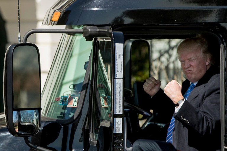 President Donald Trump gestures while sitting in an 18-wheeler truck while meeting with truckers and CEOs regarding healthcare on the South Lawn of the White House in Washington, Thursday, March 23, 2017.