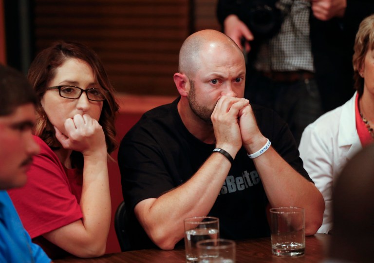 Bo Copley listens to Democratic presidential candidate Hillary Clinton during a round table discussion at Williamson Health and Wellness Center in Williamson, W.Va., Monday, May 2, 2016. (AP Photo/Paul Sancya)