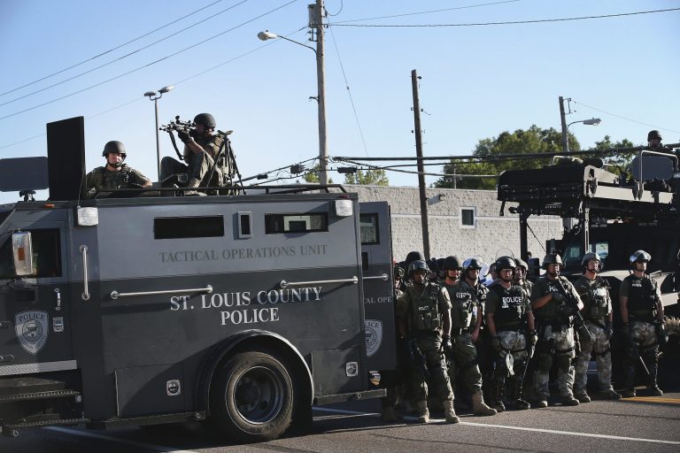 Police stand watch as demonstrators protest the shooting death of teenager Michael Brown on August 13, 2014 in Ferguson, Mo. (Getty images / Scott Olson)