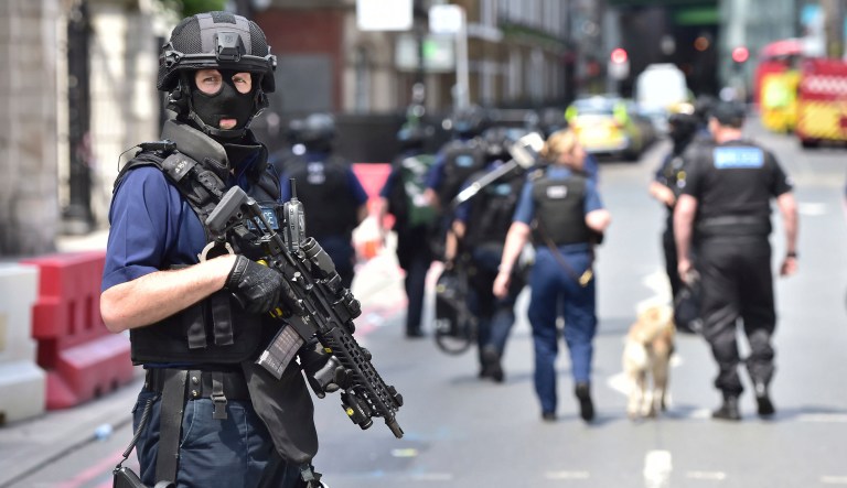 Armed police on St Thomas Street, London, Sunday June 4, 2017, near the scene of Saturday night's terrorist incident on London Bridge and at Borough Market. (Dominic Lipinski/PA via AP)