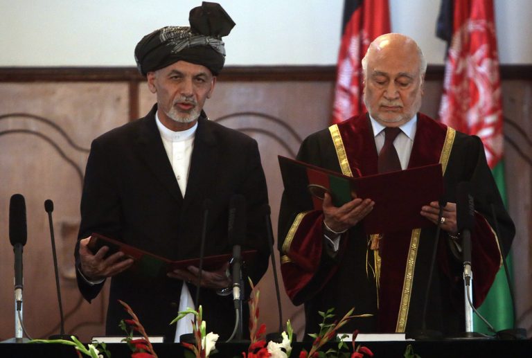 Afghan President Ashraf Ghani Ahmadzai, left, is sworn in by Chief Justice Abdul Salam Azimi, during his inauguration ceremony at the presidential palace in Kabul, Afghanistan, Monday, Sept. 29, 2014. Ghani Ahmadzai He replaces Hamid Karzai in the country's first democratic transfer of power since the 2001 U.S.-led invasion toppled the Taliban. (AP Photo/Rahmat Gul)