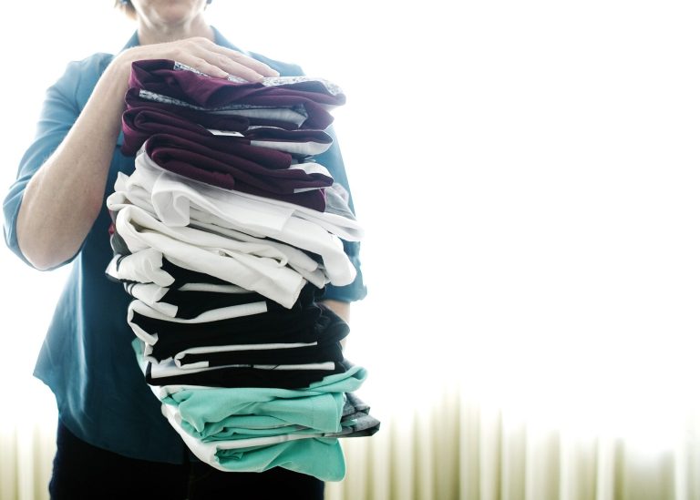 Judy Cox stands for a photograph holding a stack of T-shirts with what she believes are pornographic designs Monday, Feb. 17, 2014, in Orem, Utah. Cox purchased the entire stock of T-shirts for $567 from the PacSun store in Orem believing their display broke Orem's decency code. Cox said she complained about the window display to a store manager and was told the T-shirts couldn't be taken down without approval from the corporate office. (AP Photo/The Daily Herald, Mark Johnston)