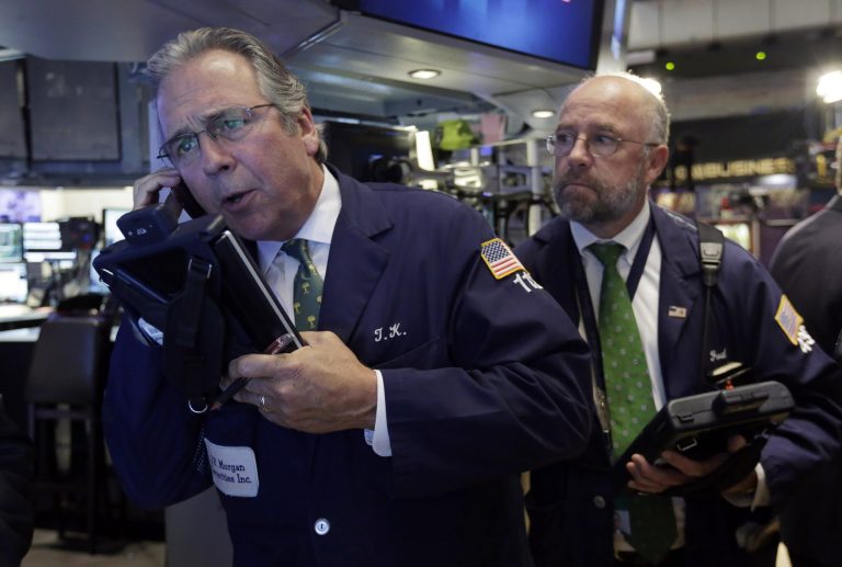 Traders Thomas Kay, left, and Frederick Reimer work on the floor of the New York Stock Exchange, Thursday, Aug. 7, 2014. U.S. stocks are opening slightly higher after Europe's main two central banks decided to keep interest rates on hold. (AP Photo/Richard Drew)