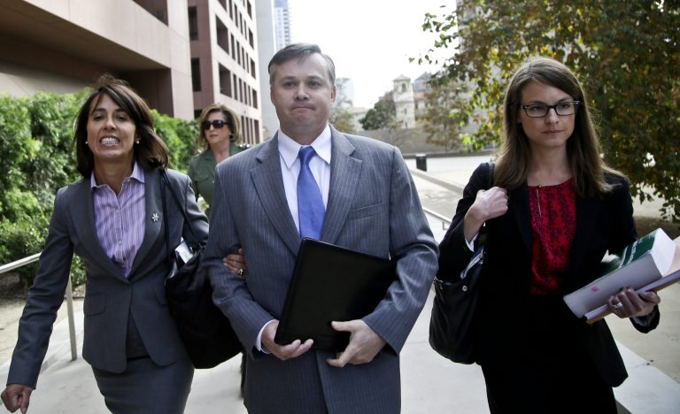 John Beliveau II, center, and his attorneys, Gretchen von Helms, left, and Jessica Carmichael arrive at the federal courthouse, Wednesday, Dec. 17, 2013, in San Diego, where Beliveau is expected to plead guilty on bribery charges in connection with the over billing of the U.S. Navy of millions of dollars. (AP/Lenny Ignelzi)