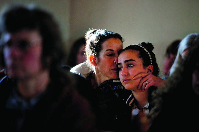 Elizabeth Bogdanoff, left, kisses her daughter Julia, 13, both of Newtown, Conn., during a prayer service at St John's Episcopal Church in Newtown, Saturday, Dec. 15, 2012. The massacre of 26 children and adults at Sandy Hook Elementary school elicited horror and soul-searching around the world even as it raised more basic questions about why the gunman, 20-year-old Adam Lanza, would have been driven to such a crime and how he chose his victims. (AP Photo/David Goldman)