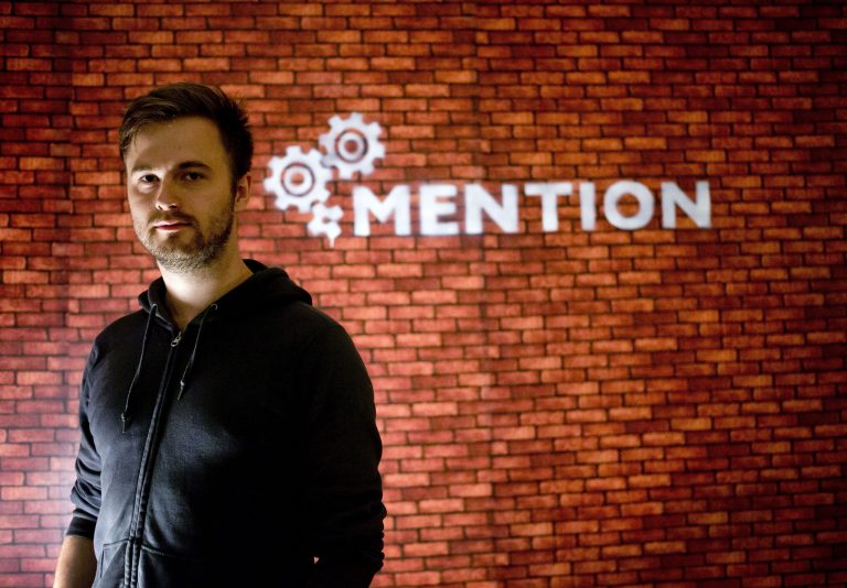 In this Sunday, June 1, 2014 photo, Nils Pihl stands near his company name at his apartment, which convert to a office in Beijing, China. Pihl has spent 18 months building what he calls cutting-edge software to crunch âreally big data sets.â But instead of going to Silicon Valley, the 27-year-old Swede and his four colleagues have been working on his invention from a small apartment overlooking smoggy northwest Beijing.  (AP Photo/Andy Wong)