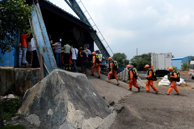 In this Aug. 19, 2014 photo, rescuers prepare to go into the Dongfang Coal Mine in Xiejiaji District of Huainan City, east China's Anhui Province, Tuesday, Aug. 19, 2014.  An explosion Tuesday in the coal mine in eastern China trapped 27 workers underground, state media reported. (AP Photo/Xinhua, Zhang Duan) NO SALES