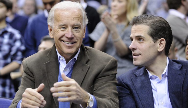Vice President Joe Biden, left, with his son Hunter, right, at the Duke Georgetown NCAA college basketball game in Washington. 