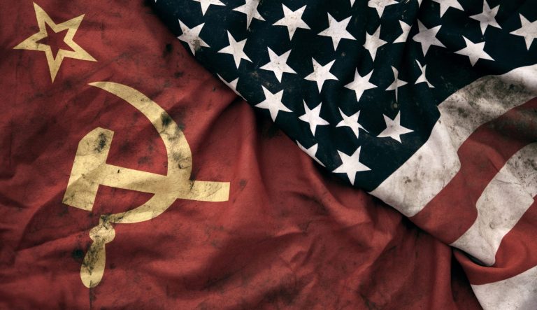 Low key photography of grungy old Soviet Union and United States of America flags. USSR, CCCP, USA.