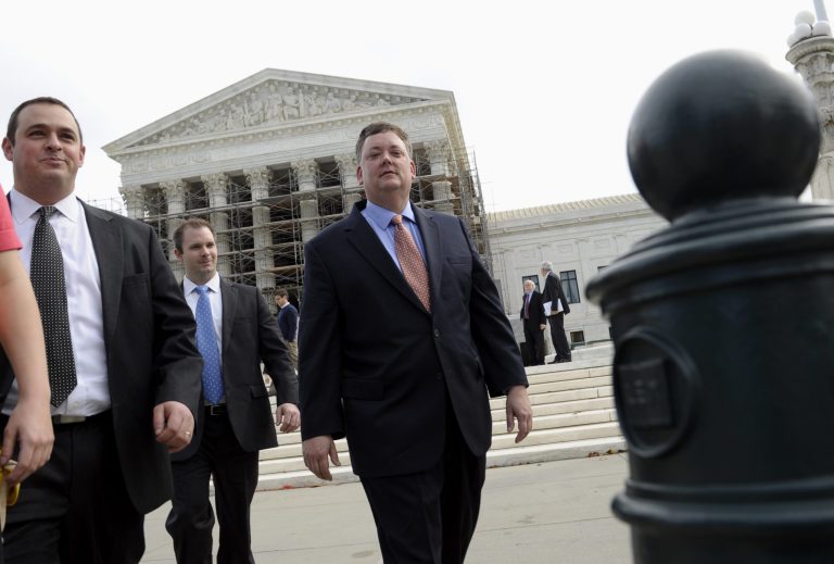 Republican activist Shaun McCutcheon of Hoover, Ala., right, leaves the Supreme Court in Washington on Tuesday, after the court's hearing on campaign finance. The Supreme Court is tackling a challenge to limits on contributions by the biggest individual donors to political campaigns. (AP Photo/Susan Walsh)