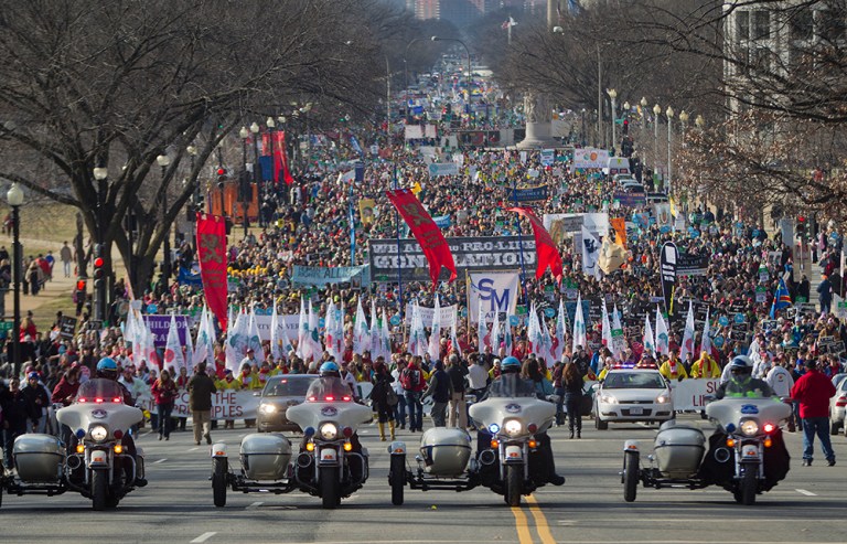 Motorcycle police escort anti-abortion demonstrators during the annual March for Life, Thursday, Jan. 22, 2015, on the National Mall in Washington. The most striking thing about the annual march, aside from the scant media coverage it typically receives, is how much it is dominated by young people.(AP Photo/Pablo Martinez Monsivais)