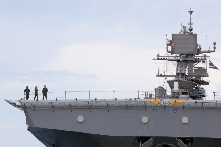 U.S. Marines stand on the edge of the flight deck of the USS Iwo Jima ship. (AP Photo/Monica Quesada)