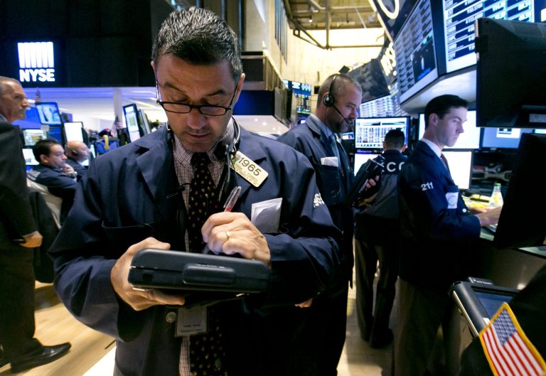 Trader Patrick Forbes, left, works on the floor of the New York Stock Exchange Thursday, Sept. 18, 2014. U.S. stocks are opening higher a day after the Federal Reserve made clear it would keep interest rates at record lows for a while. (AP Photo/Richard Drew)