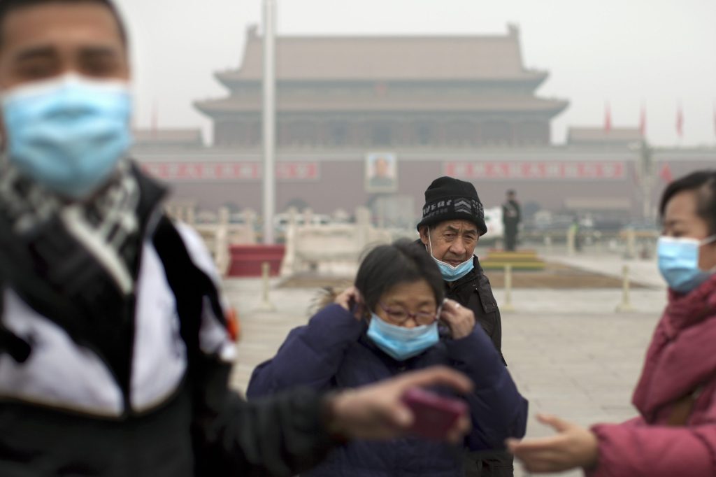 Pollution hides Beijing skyline; statues get masks