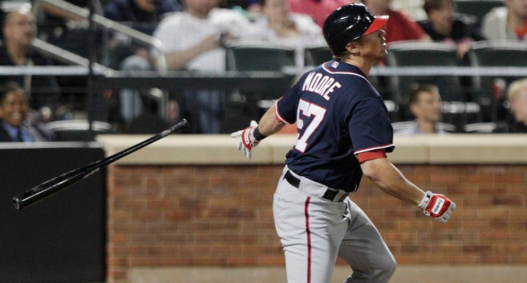 Washington Nationals' Tyler Moore (57) follows through on a two-run home run during the seventh inning of a baseball game against the New York Mets Tuesday, Sept. 11, 2012, in New York. (AP Photo/Frank Franklin II)