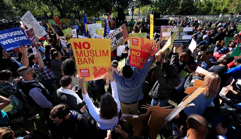 Protesters rally against the Trump travel ban in front of the White House. The Trump administration asked the 9th Circuit Court of Appeals to expedite its review of the travel ban case and remove a lower court's injunction on Trump's newest travel ban restrictions. (AP Photo/Manuel Balce Ceneta)