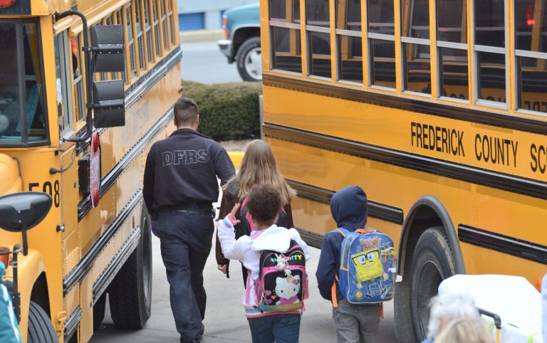 Children are led away from a school bus after the bus they were riding in was involved in a crash on Friday, March 14, 2014 in Walkersville, Md.    Capt. Tim Clarke says the children and all three drivers were taken to Frederick Memorial Hospital after the crash just before 8:30 a.m. Friday at the intersection of Route 194 and Stauffer Road. He says all injuries are minor.  Clarke says the bus carrying 27 students was traveling north on the state highway when it was struck in the side by a vehicle traveling east on Stauffer Road.  He says the back end of the bus swerved across the center line and hit a vehicle traveling south on Route 194. (AP Photo/The Frederick News-Post, Graham Cullen)