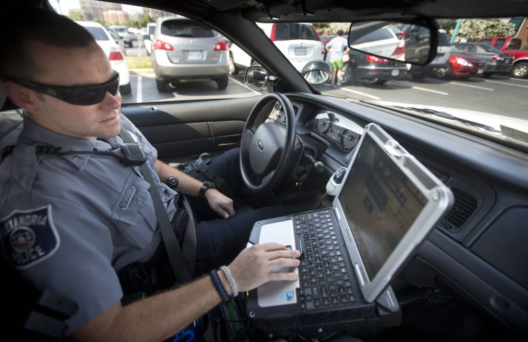 Alexandria, Va. Police Office Dennis Vafier uses a laptop in his squad car to scan vehicle license plates during his patrol of the area.  (AP/Pablo Martinez Monsivais)