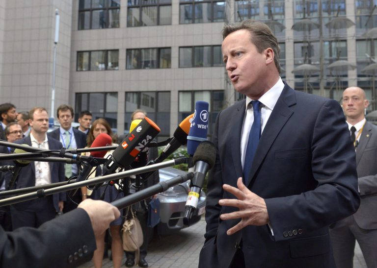 British Prime Minister David Cameron addresses the media upon arrival at the European Council building in Brussels, Tuesday, May 27, 2014.  European Union leaders on Tuesday sought a way to bounce back from the weekend's landmark elections that saw a partly hostile and largely apathetic public question their project of closer cooperation as never before. (AP Photo/Eric Vidal)