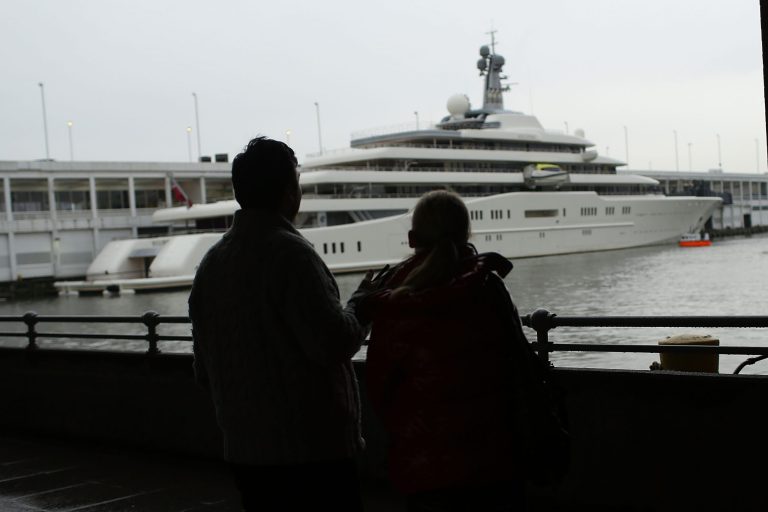 A couple looks out at the Eclipse, reported to be the largest private yacht in the world, which is docked at a pier in New York on Feb. 19, 2013. (Photo by Spencer Platt/Getty Images)